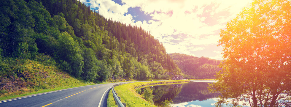 Driving a car on a mountain road along the fjord. Nature Norway