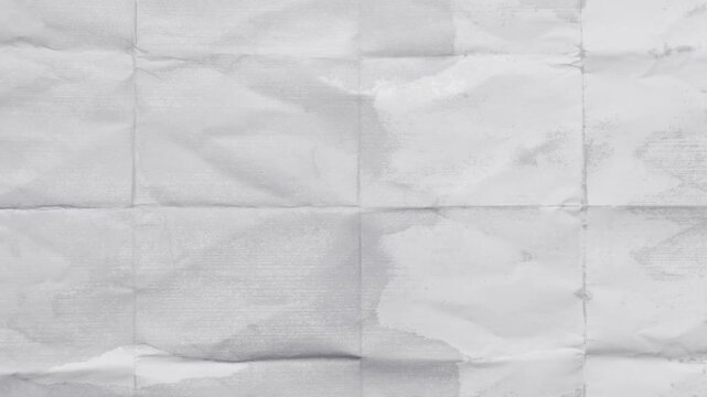 Abstract crumpled paper texture in grayscale showing folds and creases perfect for backdrops and designs