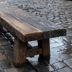 Fototapeta premium Rustic Wooden Bench on Wet Pavement After Rain