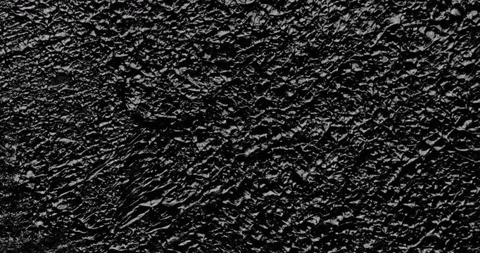 Black grunge background. Сlose-up. A high-resolution dark texture background captured in smooth motion.