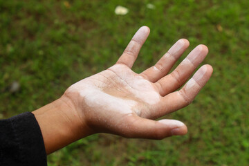 Close up of dirty hands covered in flour or white dust outdoors