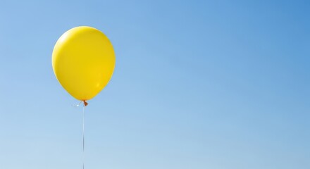 Fototapeta premium Vibrant Yellow Balloon against a Bright Blue Sky with Ample Copy Space for Celebrations and Joyful Concepts