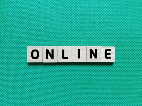 Alphabet letters of the word ONLINE on a green background. Concept photo about internet system or technology network.