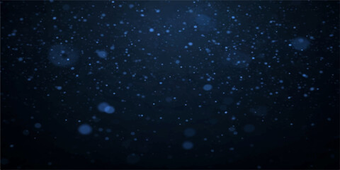 Obraz premium A festive winter night sky filled with falling snowflakes and rain drops on a dark window creates a starry blue galaxy pattern of light and water particles for a Christmas holiday design