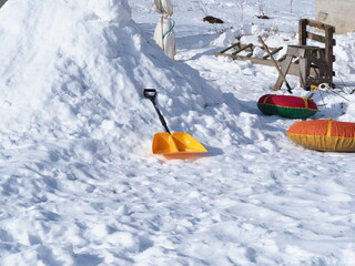 yellow snow shovel lying on the snow