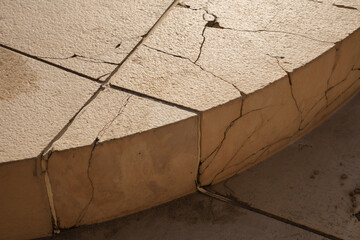 Cracked concrete surface with erosion in sunlight infrastructure repair maintenance concept