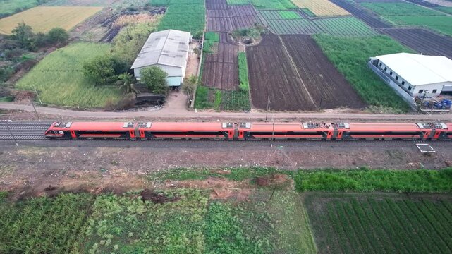 Saffron coloured Vande Bharat Express near Pune India. This is a made in India train set and also known as Train 18.