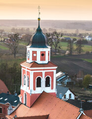 Zabytkowy kościół św. Jerzego i kolorowe kamienice w Prószkowie na Opolszczyźnie. Malowniczy widok z góry na architekturę miasteczka w porannym słońcu. Idealne zdjęcie podróżnicze i krajobrazowe. © Henryk Niestrój