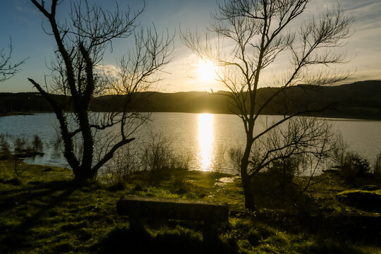 Beautiful landscape of a sunrise over the forest with a lake in the background