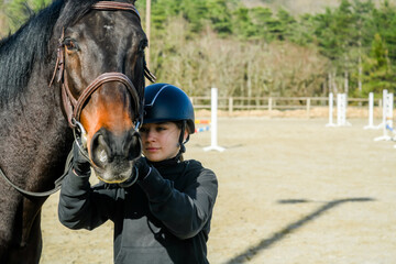 Young rider and her horse in close-up