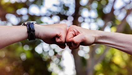 Deal of teamwork with the Man hand a fist bump commit as get together in the office