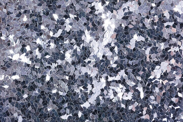 Christmas holographic glitter background with shiny surface, texture in grey tone.