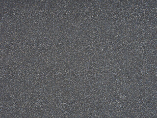 Dark grey glitter texture closeup. Design pattern of holographic sparkling shiny glitter for decoration and design of unusual, extravagant Christmas, New Year, xmas gift card or other holiday pictures