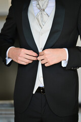 Man Buttoning His Tuxedo Jacket for a Formal Event