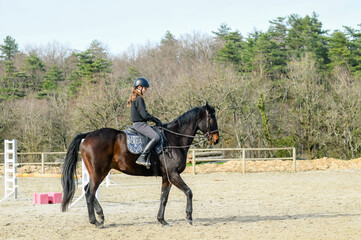 Portrait of a beautiful rider performing cross-walks with her horse