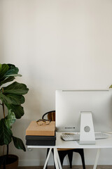 Simple Workspace Mockup With Desktop Monitor, Copy Space Wall, And Storage Boxes