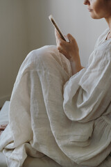 Calm Digital Lifestyle Scene With Woman Using Mobile Phone In Quiet Minimal Room Copy Space
