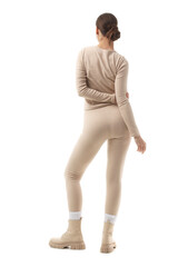 Naklejka premium Young woman in thermal underwear with boots on white background, back view