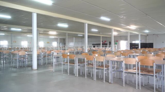 Modern interior of cafeteria or canteen with chairs and tables, eating room in selective focus. canteen at the factory