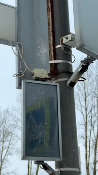 Green Pedestrian Walk Signal Showing Countdown And Animated Walking Icon On LED Display Transparent Casing, Pole Mounting And Tree Background Suggest Urban Intersection, Evening Commute.