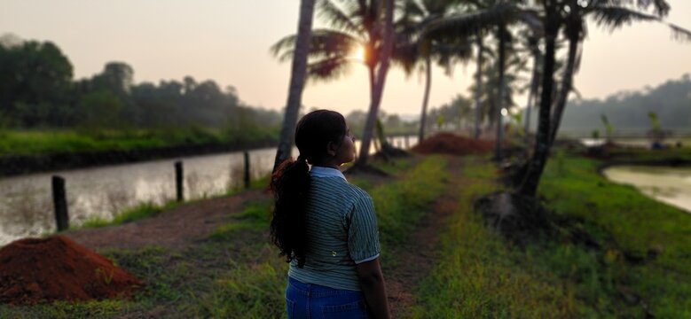 young couple walking in the park at sunset