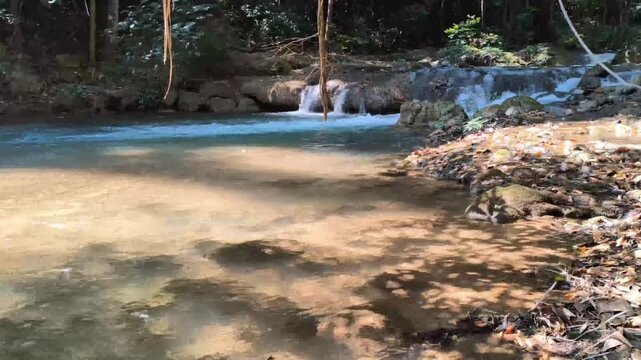 flowing water stream creek cascade waterfall in tropical forest