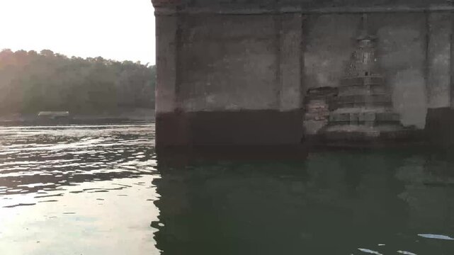 traveling sailing on river lake pond to see old temple sank in water