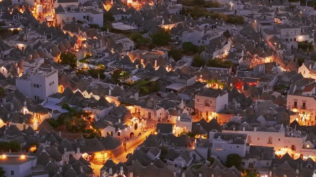 Aerial night view of the illuminated Trulli in Alberobello, Puglia, Italy