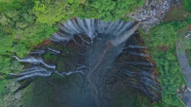 Aerial drone flying over tumpak sewu waterfall in indonesia