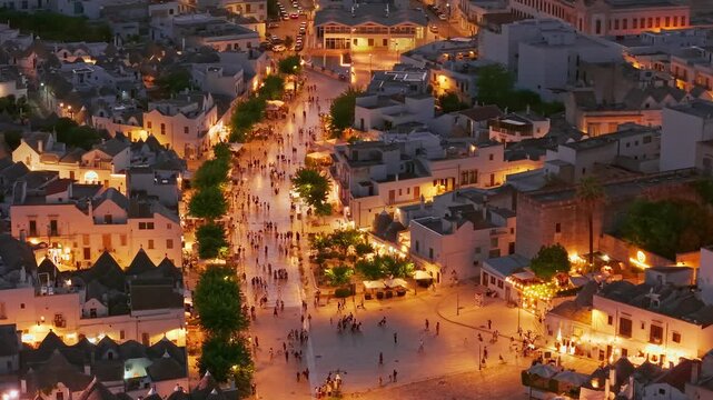 Aerial night view of the illuminated Trulli in Alberobello, Puglia, Italy