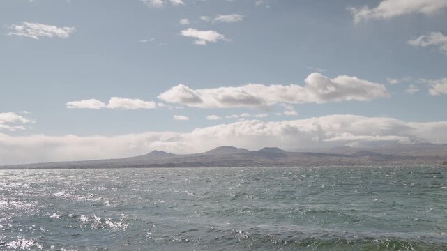 Slow motion handheld footage of lake Sevan in Armenia windy autumn season