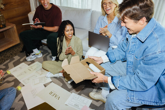 Coworkers designing packaging and marketing for new hybrid wellness brand