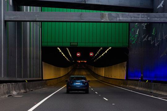 Blue car driving towards M11 tunnel entrance to bypass under Sydney 