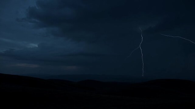 A dramatic lightning storm unfolds over a dark landscape at dusk from a low vantage point
