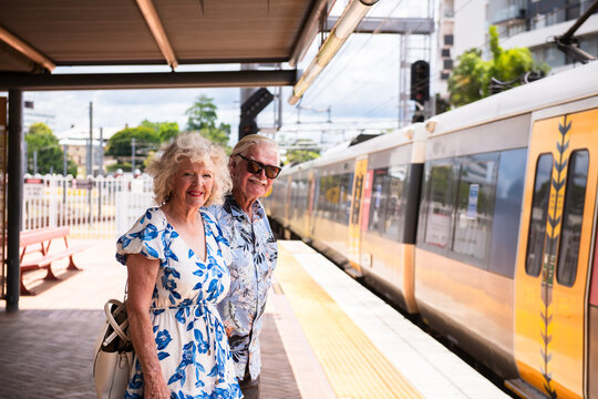 senior couple taking the train