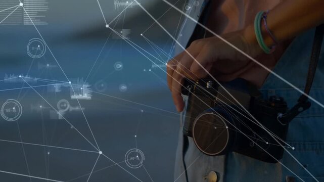 Hand holding camera with network connections and data processing animation overlay