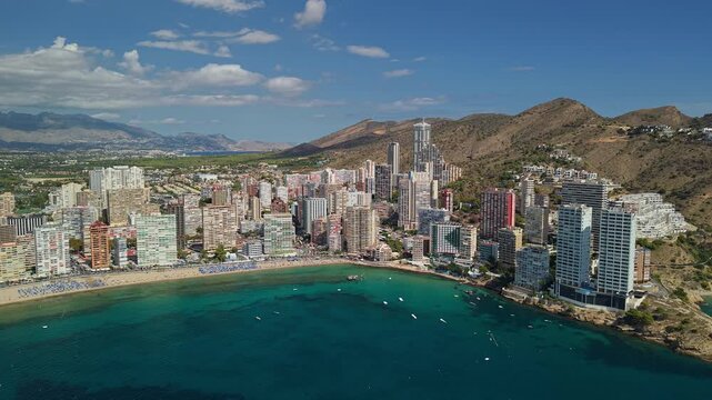 Aerial panorama of Benidorm bay with turquoise Mediterranean water and modern coastal skyline Spain