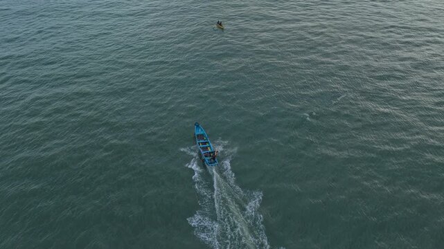 Aerial view of fishing boats sailing on java sea at sunset
