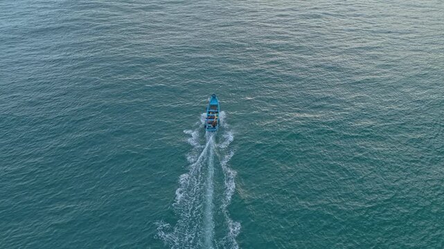 Aerial view following fishing boat sailing in java sea