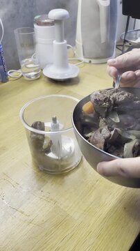 The process of making chicken liver pate. A hand blender grinds the liver into pate