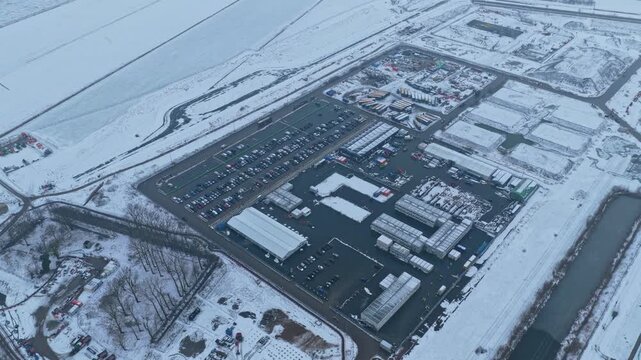 Aerial view of a data center construction site in winter with wind turbine
