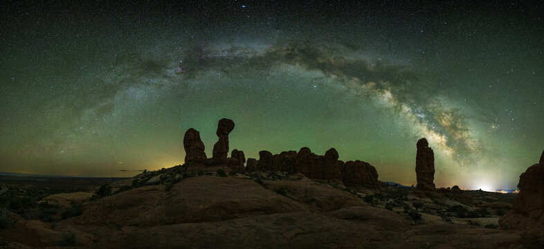 Garden Eden in Arches Nationalpark near Moab, Utah. Milkyway arch over the beautiful rock formation. Tracked panorama for the sky, untracked for the foreground. Green airglow.