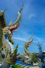 Beautiful public Buddhist church at Wat Rong Sua Ten temple in Chiang Rai. Naga:Stucco art sky backgrounds
