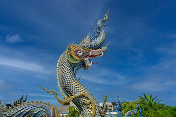 Fototapeta premium Beautiful public Buddhist church at Wat Rong Sua Ten temple in Chiang Rai. Naga:Stucco art sky backgrounds 