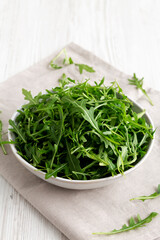 Organic Raw Green Arugula in a Bowl, side view.
