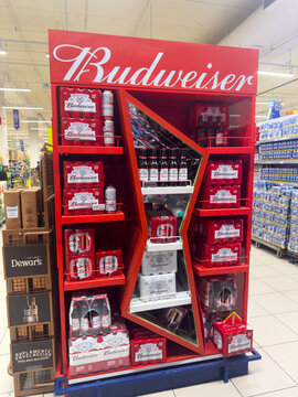 BELO HORIZONTE, MG, BRAZIL, FEBRUARY 19, 2026. An eye-catching red Budweiser sales display, filled with different beer products, stands out in a brightly lit supermarket shopping aisle.