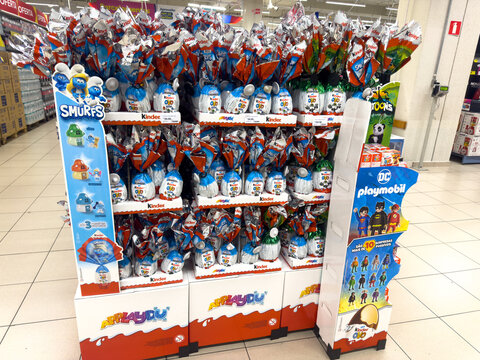 BELO HORIZONTE, MG, BRAZIL, FEBRUARY 19, 2026. A large promotional stand in a supermarket is filled with Kinder Surprise Easter eggs featuring Smurfs and DC Playmobil branding.