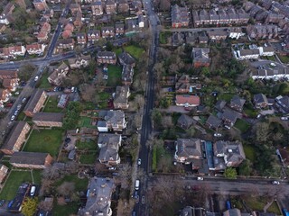 Drone image of Birkenhead residential blocks with long shadows and warm tones.