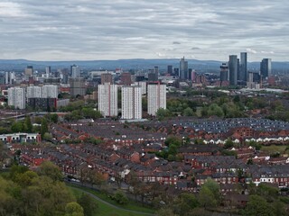 Fototapeta premium Skyline view of a cityscape showcasing residential areas and modern buildings on a cloudy day