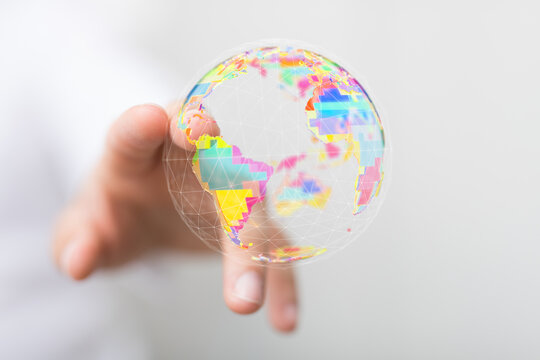 A hand gently holds a vibrant globe showcasing the world, symbolizing connection, networking, and global unity. Ideal fo